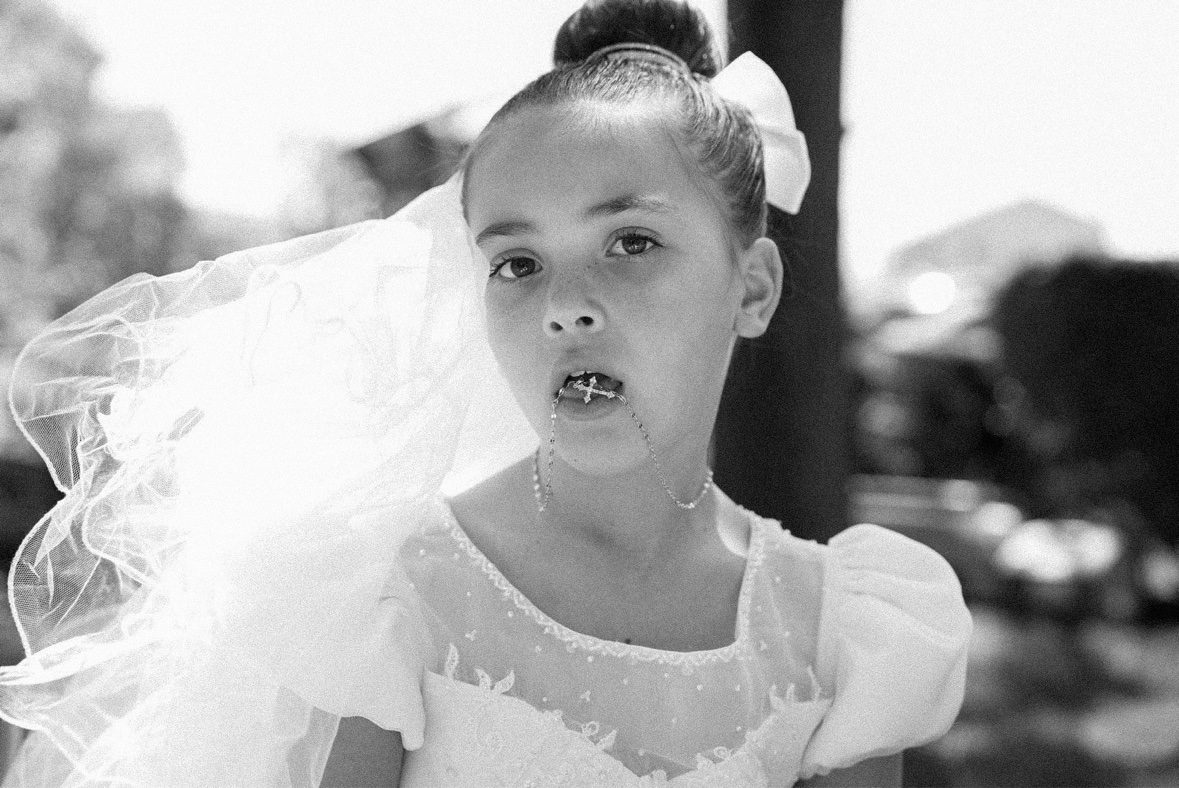 Black and white portrait of a young girl in a communion dress