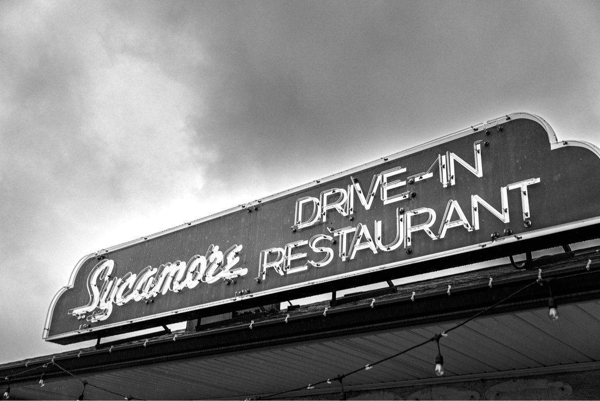 Black and white photograph of the Sycamore Drive-In neon sign